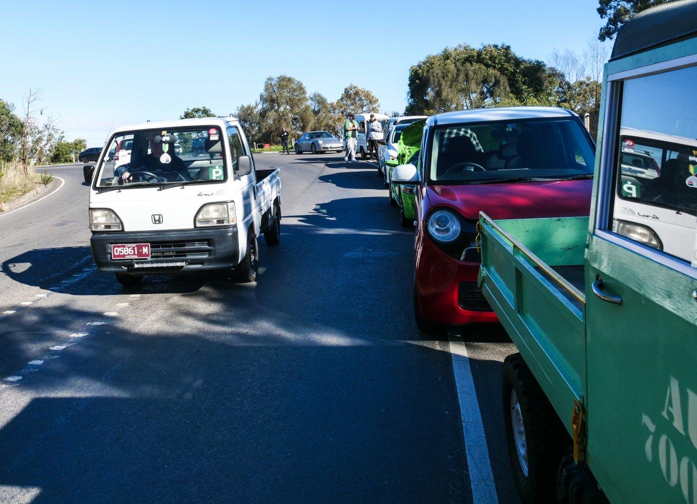 Line of Kei trucks and cars.